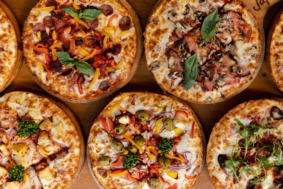 A selection of Japes London Style pizzas with caramelised cheese edges and different toppings