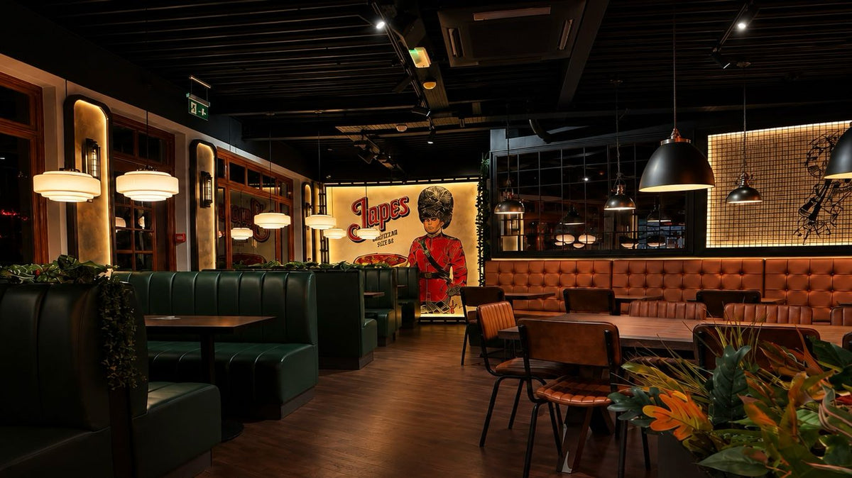 Japes Windsor dining room with green booths, warm lighting and a royal guard mural